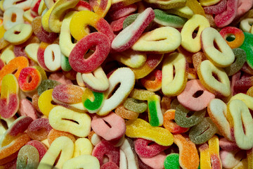 A bunch of colorful marmalade candies in the form of a ring (bagel), sprinkled with sugar or citric...
