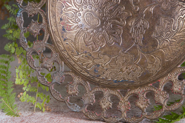 Old brass bowl and green plant