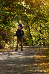 Fototapeta premium Father with son on his shoulders walking in the autumn park.