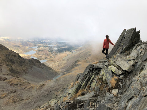 Woman hiker on Carlit peak, Pyrenees, France.
