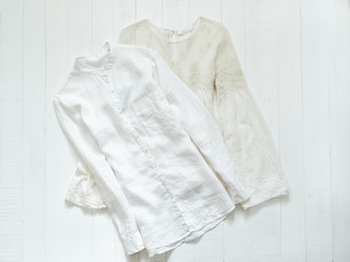 Embroidered blouse and white shirt on a white background. Clothing concept