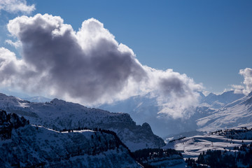 Panorama of winter Alps with clouds