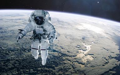 Astronaut on background of the Earth. Solar system. Science fiction. Elements of this image...