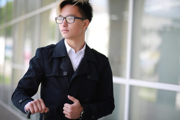 Spring rainy weather and a young man with an umbrella