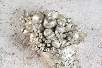 Vintage horn of cornucopia on concrete background.