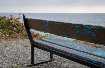 Fototapeta na wymiar Bench by the sea. Seascape.