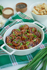 Fried Cauliflower in Sauce and Sesame. Asian style dish. White wood background.