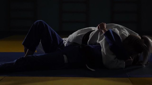 women are fighting on the tatami. judo