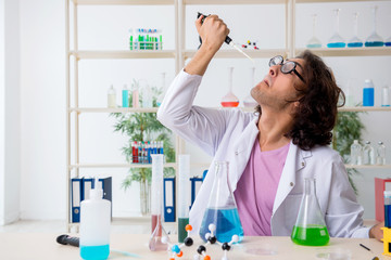 Funny male chemist working in the lab