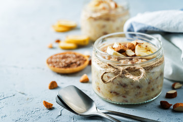 Banana flax seeds overnight oats with banana slices and almonds - Powered by Adobe