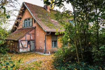 Old hidden house in autumn landscape - close up