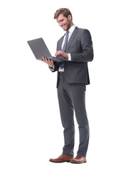 in full growth. businessman standing with open laptop