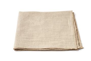 Single beige textile napkin on white background