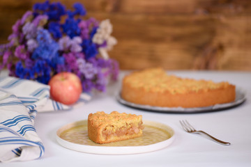 A piece of apple pie on white backstage.