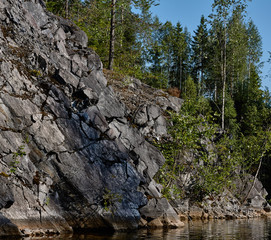 The picturesque landscape of the mountain natural park Ruskeala. Visible are rocks, a lake, coniferous forest, mountains, wildlife. Russia, Karelia.Water landscape of a mountain park