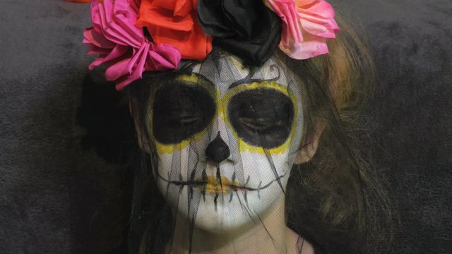 Little girl with Day of the Dead make up and Costume.Halloween makeup ideas concept