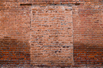 The road to the past and the future is buried, you need to live in the present. The door is laid with red bricks in a large brick wall.