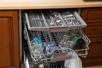 Dishwasher with washed dishes. Repair of dishwashers.