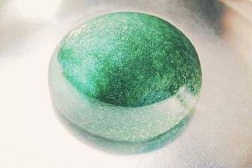 Light green konjac sponge in water. Facial massage and exfoliating beauty accessory.