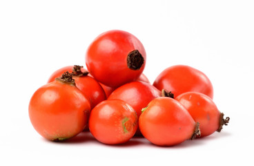 Heap of fresh rose hip isolated on white background