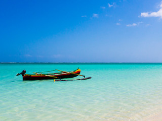 Colorful fishermen pirogue moored on turquoise sea of Nosy Ve island, Indian Ocean, Madagascar - obrazy, fototapety, plakaty