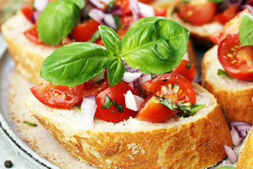 fresh tomato bruschetta. italian food appetizer with basil on table