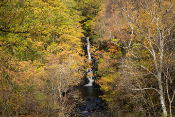 the powerfall waterfalls and overflow in the village of kinlochleven in the argyll region of the highlands of scotland during autumn