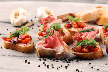 Assorted bruschetta with various toppings. Appetizing bruschetta or crudo crostini. Variety of small sandwiches. Mix bruschetta on table