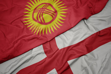 waving colorful flag of england and national flag of kyrgyzstan.