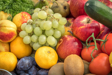 Different fruits and vegetables all over the table