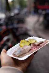 herring with cucumber, Dutch herring on a plate (vertically)