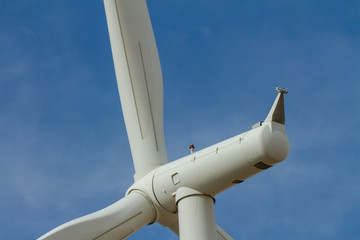 close up of a wind turbin against a blue sky