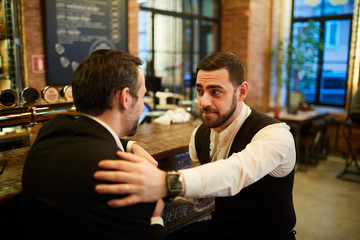 Portrait of two successful business people chatting sitting by bar after work and relaxing, copy space