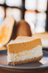 Piece of pumpkin homemade cake. Festive dessert concept. pumpkin tart on cozy cafe background, selective focus, noise effect