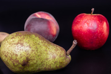 fresh healthy fruits on the black background.