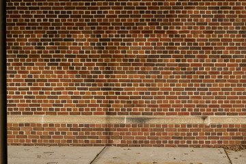 Reddish brown color vintage brick wall texture with a quilted look, showing faint shadows of a tree...