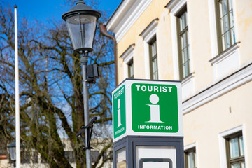 Green Tourist information sign in the city center. Tourist point, help desk, city guide