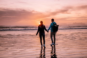 Tofino Vancouver Island, sunset at cox bay with surfers by the ocean during fall season Canada © Fokke Baarssen