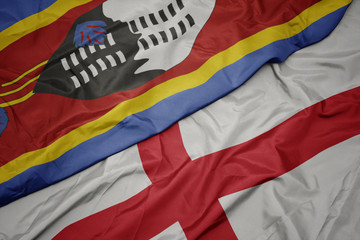 waving colorful flag of england and national flag of swaziland.