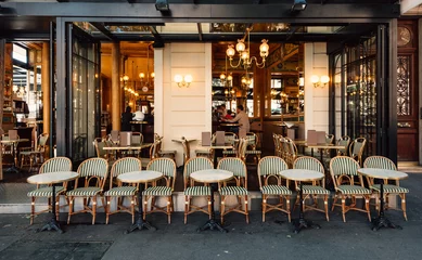 Zelfklevend Fotobehang Typical view of the Parisian street with tables of brasserie (cafe) in Paris, France © Ekaterina Belova