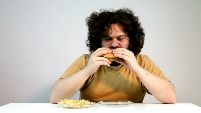 Very Hungry Obese Man Eating Fast Food