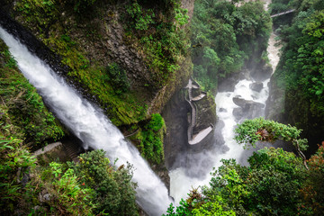 El Pailon del Diablo waterfall. The amazing stream of water and all its strenght can be perceived. In the middle of the image you can see a stair in which you can get closer tot he waterfall. Ecuador.