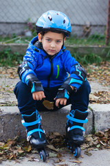 Cute little boy in a helmet on rollers