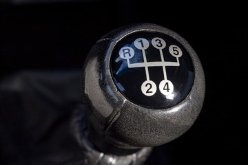 Car manual gear box. Close up view of a gear lever shift. Car interior details.