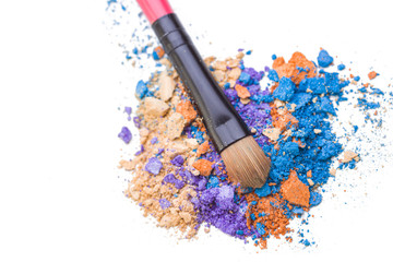 Colorful crushed eyeshadows with brush, makeup accessories.