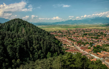 Fototapeta na wymiar Ancient city of Rasnov in Romania. Panorama of the city from the air