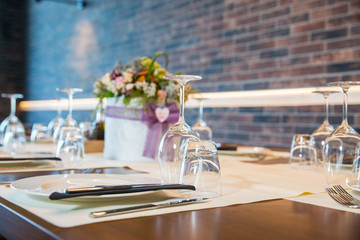 Luxury elegant table setting for dinner at a restaurant with flowers