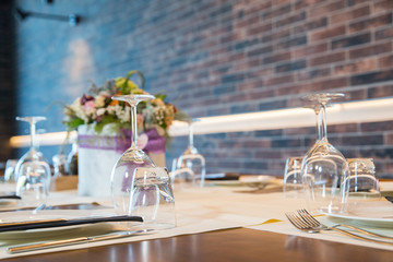 Luxury elegant table setting for dinner at a restaurant with flowers