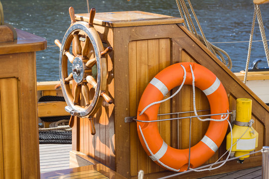 Steering wheel and life ring on the boat. Sailing and marine 