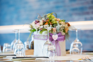Luxury elegant table setting for dinner at a restaurant with flowers